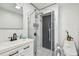 Modern bathroom features a walk-in shower with glass enclosure, toilet, and sleek vanity at 1130 Big Creek Dr, Wesley Chapel, FL 33544