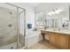 Bright bathroom featuring a glass enclosed shower, soaking tub, and wood vanity at 1130 Big Creek Dr, Wesley Chapel, FL 33544