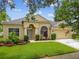 Well-kept home with a verdant lawn, landscaped garden beds and an inviting facade at 1130 Big Creek Dr, Wesley Chapel, FL 33544