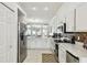 Bright kitchen features stainless steel appliances, white cabinetry and tile backsplash at 1130 Big Creek Dr, Wesley Chapel, FL 33544