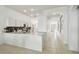 View of the kitchen and long hall with an arched doorway to the foyer at 1130 Big Creek Dr, Wesley Chapel, FL 33544