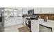 Modern kitchen with stainless steel appliances, white cabinets and tiled backsplash at 1130 Big Creek Dr, Wesley Chapel, FL 33544