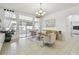 Bright living room with tile flooring, sofa, two chairs and natural light at 1130 Big Creek Dr, Wesley Chapel, FL 33544