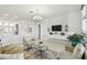 Open-concept living room with stylish decor, TV, chandelier, and tile flooring at 1130 Big Creek Dr, Wesley Chapel, FL 33544