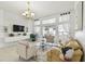 Open-concept living room with stylish decor, TV, chandelier, and tile flooring at 1130 Big Creek Dr, Wesley Chapel, FL 33544