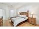 Inviting main bedroom with wood floors, detailed wood furniture, and ample natural light at 1130 Big Creek Dr, Wesley Chapel, FL 33544