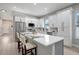 Modern kitchen with white cabinets, quartz countertops, and an island at 3410 E Henry Ave, Tampa, FL 33610