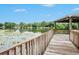 Wooden dock with gazebo offering scenic lake views at 7156 E Bank Dr # 7156, Tampa, FL 33617