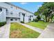 Two-story building exterior with landscaping and parking at 7156 E Bank Dr # 7156, Tampa, FL 33617