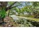 Serene canal view with lush foliage and bridge at 7156 E Bank Dr # 7156, Tampa, FL 33617