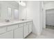 Double vanity bathroom with quartz countertop and walk-in closet at 3008 Forest Meadow Ave, Valrico, FL 33594
