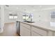 Kitchen island with sink and dishwasher overlooking the living area at 3008 Forest Meadow Ave, Valrico, FL 33594
