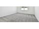 Spacious bedroom with grey carpet and large window at 3008 Forest Meadow Ave, Valrico, FL 33594