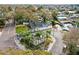 Aerial view of a waterfront home with a screened-in pool, private dock, and lush landscaping at 8320 Boxwood Dr, Tampa, FL 33615