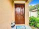 Inviting front door entrance with a welcome mat and keyless entry at 3011 Moulden Hollow Dr, Zephyrhills, FL 33540