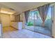 Bright kitchen with white cabinets, tile floor, and sliding glass doors leading to a patio at 11728 Raintree Dr, Temple Terrace, FL 33617