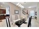 Elegant dining room with a glass table, stylish chairs, and modern lighting at 11329 Emerson Lake Dr, Riverview, FL 33578