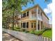 Charming two-story home with a white picket fence and lovely landscaping at 11329 Emerson Lake Dr, Riverview, FL 33578