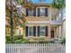 Inviting two-story home featuring dark shutters and a quaint front porch at 11329 Emerson Lake Dr, Riverview, FL 33578