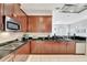 Stylish kitchen featuring dark cabinets, black countertops, and stainless steel appliances at 11329 Emerson Lake Dr, Riverview, FL 33578