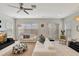Bright living room with modern furniture, a ceiling fan, and an open floor plan at 11329 Emerson Lake Dr, Riverview, FL 33578