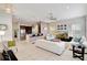 Spacious living room featuring a ceiling fan, white tile flooring, and an open layout at 11329 Emerson Lake Dr, Riverview, FL 33578