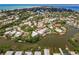 Breathtaking aerial view of a coastal community with waterfront homes and lush greenery at 210 Lakeview Dr, Anna Maria, FL 34216