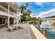Picturesque backyard view showcasing a dock, boat lift, and lush landscaping, offering direct access to the waterway at 210 Lakeview Dr, Anna Maria, FL 34216