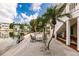 Scenic backyard featuring a charming seating area with lush tropical landscaping and serene waterfront views at 210 Lakeview Dr, Anna Maria, FL 34216