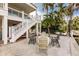 Quaint backyard with cozy outdoor seating, lush tropical foliage, and peaceful waterfront views, ideal for entertaining at 210 Lakeview Dr, Anna Maria, FL 34216