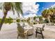 Relaxing backyard with comfortable seating, swaying palms, and breathtaking waterfront scenery for the ultimate getaway at 210 Lakeview Dr, Anna Maria, FL 34216