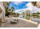 Inviting backyard view with a waterfront, dock, and boat lift, set against a clear, blue sky at 210 Lakeview Dr, Anna Maria, FL 34216