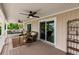 Relaxing balcony with comfortable seating, ceiling fans, and views, perfect for enjoying the waterfront ambiance at 210 Lakeview Dr, Anna Maria, FL 34216