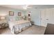Comfortable bedroom with seafoam walls, ceiling fan, and ensuite bathroom access at 210 Lakeview Dr, Anna Maria, FL 34216