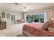 Large bedroom with ceiling fan, balcony access and seating, and writing desk at 210 Lakeview Dr, Anna Maria, FL 34216