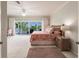 Large bedroom with ceiling fan, balcony access, and space for seating at 210 Lakeview Dr, Anna Maria, FL 34216