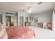 Large bedroom with balcony access, desk area, and en suite bath at 210 Lakeview Dr, Anna Maria, FL 34216
