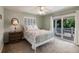 Comfortable bedroom with sliding glass door leading to a balcony at 210 Lakeview Dr, Anna Maria, FL 34216