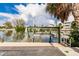 Waterfront with a boat lift, calm water, and neighboring house, ideal for boating enthusiasts and picturesque views at 210 Lakeview Dr, Anna Maria, FL 34216
