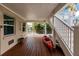 Cozy outdoor deck showcasing wood floors, under stair storage, and a vibrant red kayak for waterfront adventures at 210 Lakeview Dr, Anna Maria, FL 34216