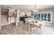 Dining room open to updated kitchen, stairs to upper level, and plenty of natural light at 210 Lakeview Dr, Anna Maria, FL 34216
