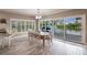 Dining area with sliding glass door that leads to outdoor deck and waterfront view at 210 Lakeview Dr, Anna Maria, FL 34216