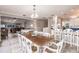Bright dining room leads to living room and modern kitchen with barstool seating at 210 Lakeview Dr, Anna Maria, FL 34216