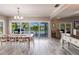 Dining room area with a large wooden table and seating, looking out onto a waterfront view at 210 Lakeview Dr, Anna Maria, FL 34216