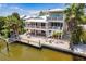Charming waterfront home boasts a private dock, spacious balconies, and inviting outdoor area at 210 Lakeview Dr, Anna Maria, FL 34216