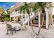 Stunning multi-level home featuring a patio, balcony, outdoor seating, and private waterway access at 210 Lakeview Dr, Anna Maria, FL 34216