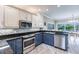 Lovely eat-in kitchen featuring stainless appliances, custom backsplash and modern cabinetry at 210 Lakeview Dr, Anna Maria, FL 34216