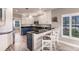 Updated kitchen with stainless steel appliances, granite countertops, and bar stool seating at 210 Lakeview Dr, Anna Maria, FL 34216
