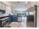 Well-equipped kitchen boasts stainless appliances and views into the sunny dining area at 210 Lakeview Dr, Anna Maria, FL 34216