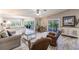 Spacious living room with tile floors and sliding glass doors with a view at 210 Lakeview Dr, Anna Maria, FL 34216
